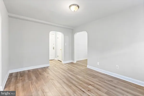 a kitchen with stainless steel appliances granite countertop a refrigerator a stove and a sink with wooden floors