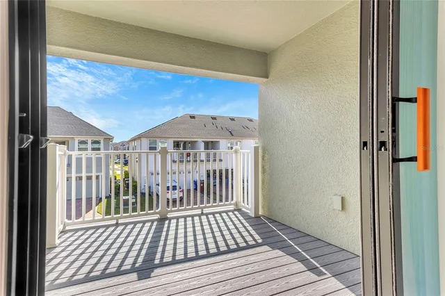 a view of a balcony with wooden floor