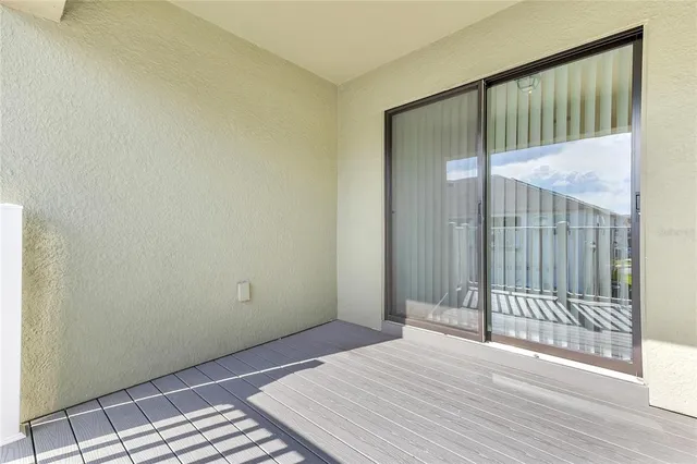 a view of a room with wooden floor and windows