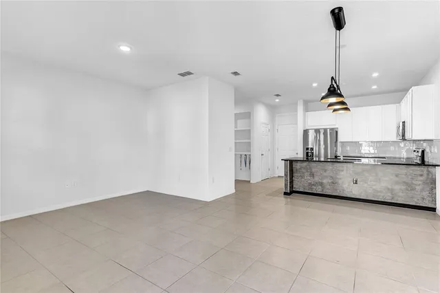 a view of a kitchen with a sink cabinets and appliances