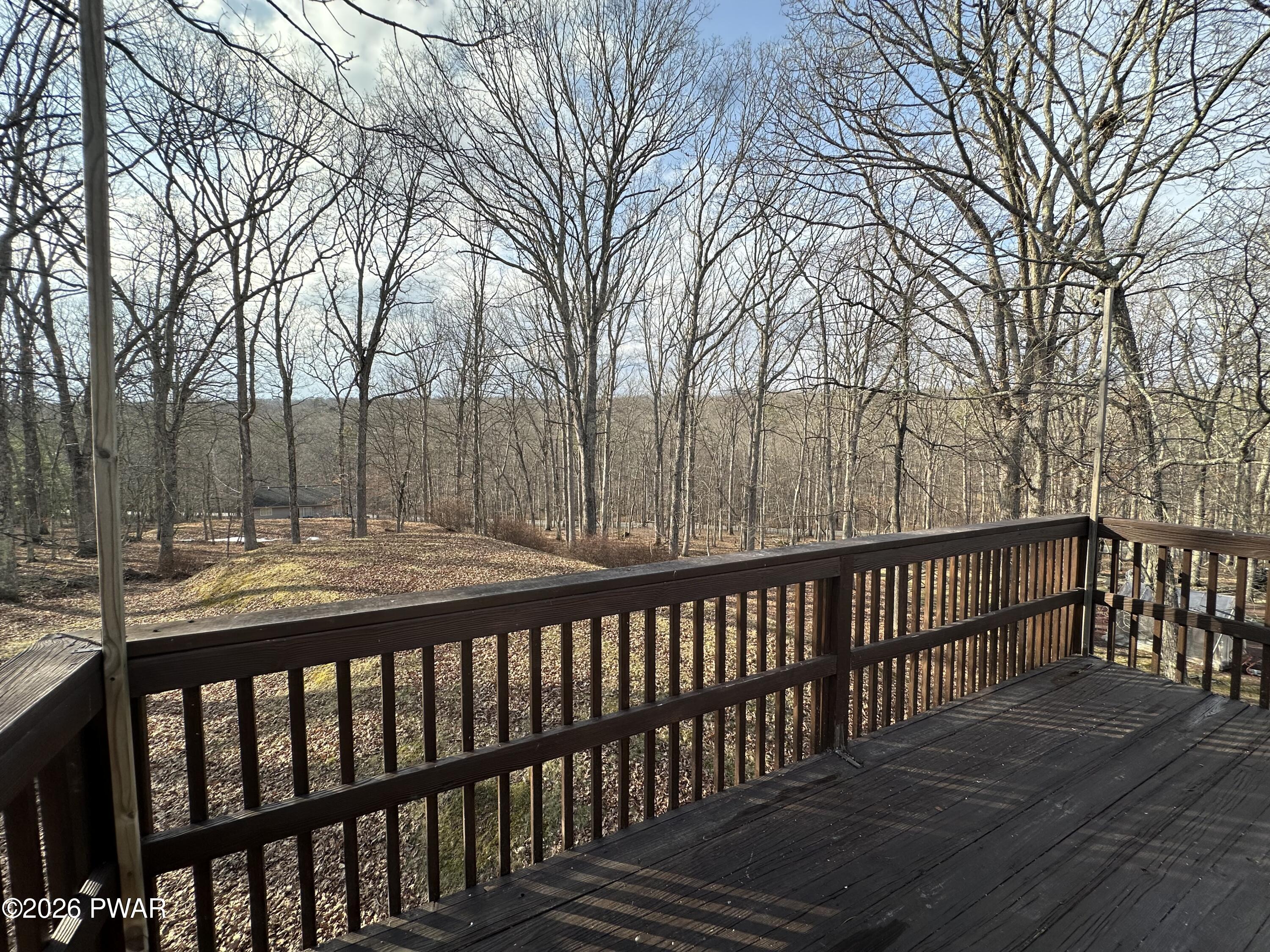 2116 Spring Drive Bushkill, PA 18324 - Photo 7 of 19 a view of balcony with wooden floor and fence
