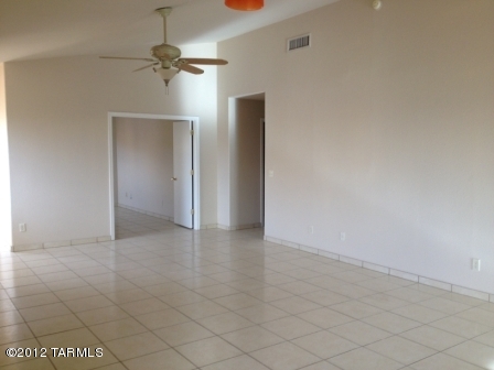 6096 South Nantac Rim Drive Tucson, AZ 85706 - Photo 3 of 5 an empty room with a ceiling fan and carpet