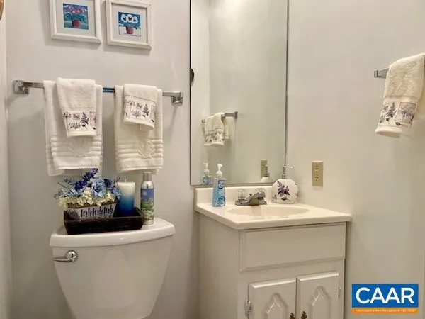 a spacious bedroom with a bed and dresser with mirror