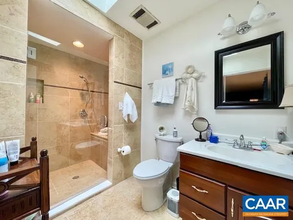 a bedroom with a bed and dresser with mirror