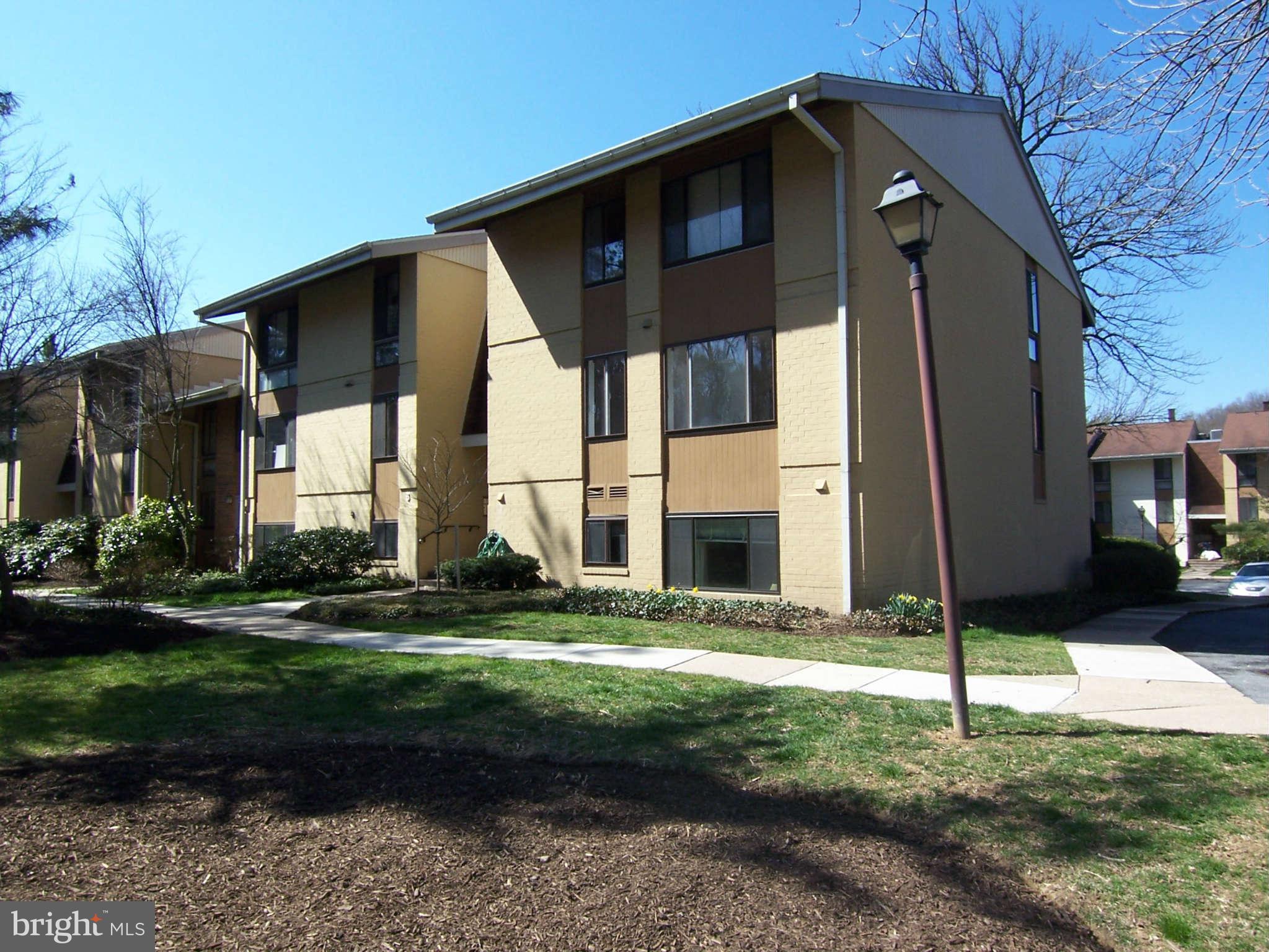 5 Cross Keys Road, Unit 5D Baltimore, MD 21210 - Photo 1 of 16 a front view of a house with a yard