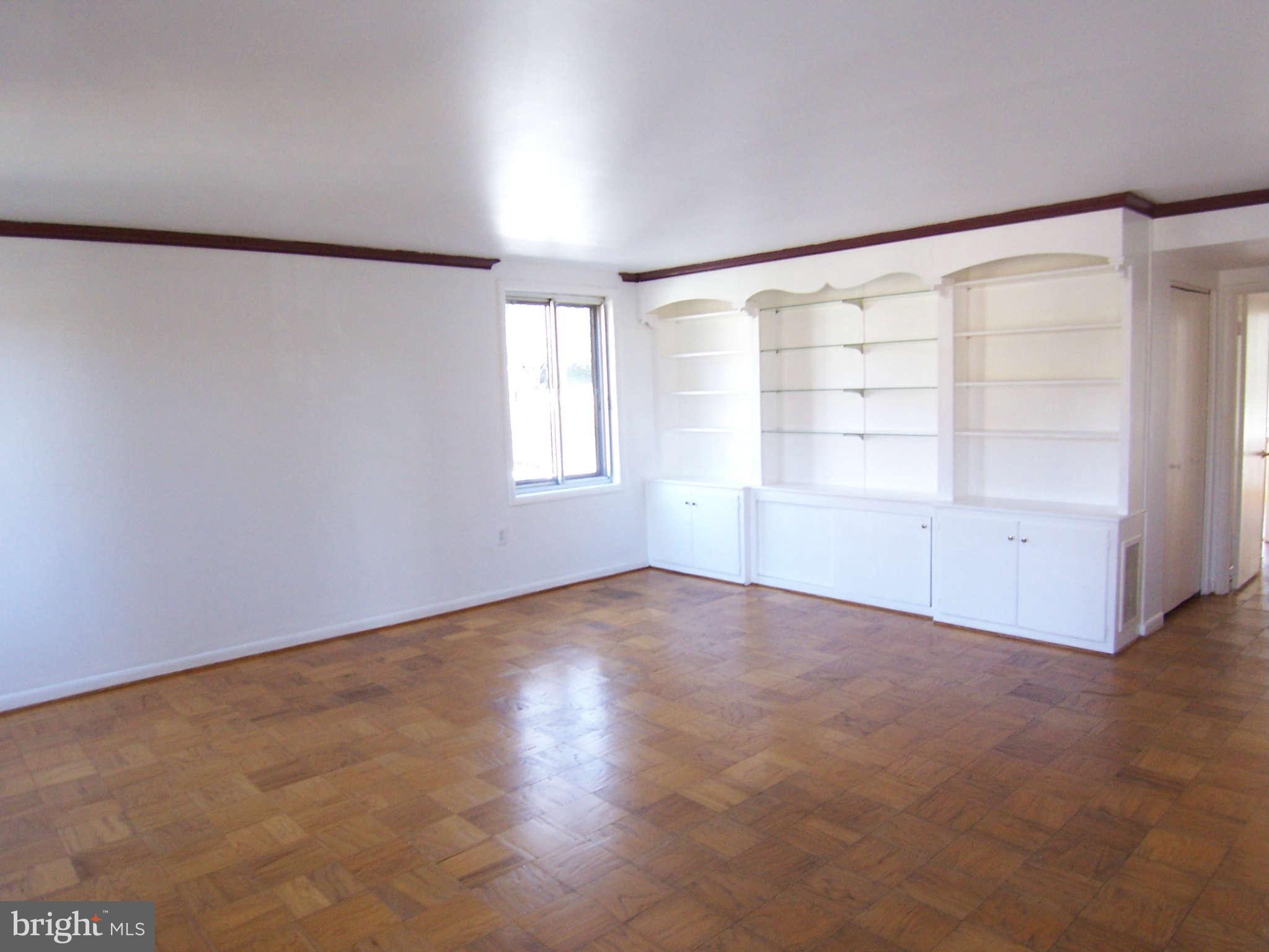 5 Cross Keys Road, Unit 5D Baltimore, MD 21210 - Photo 2 of 16 an empty room with windows and closet