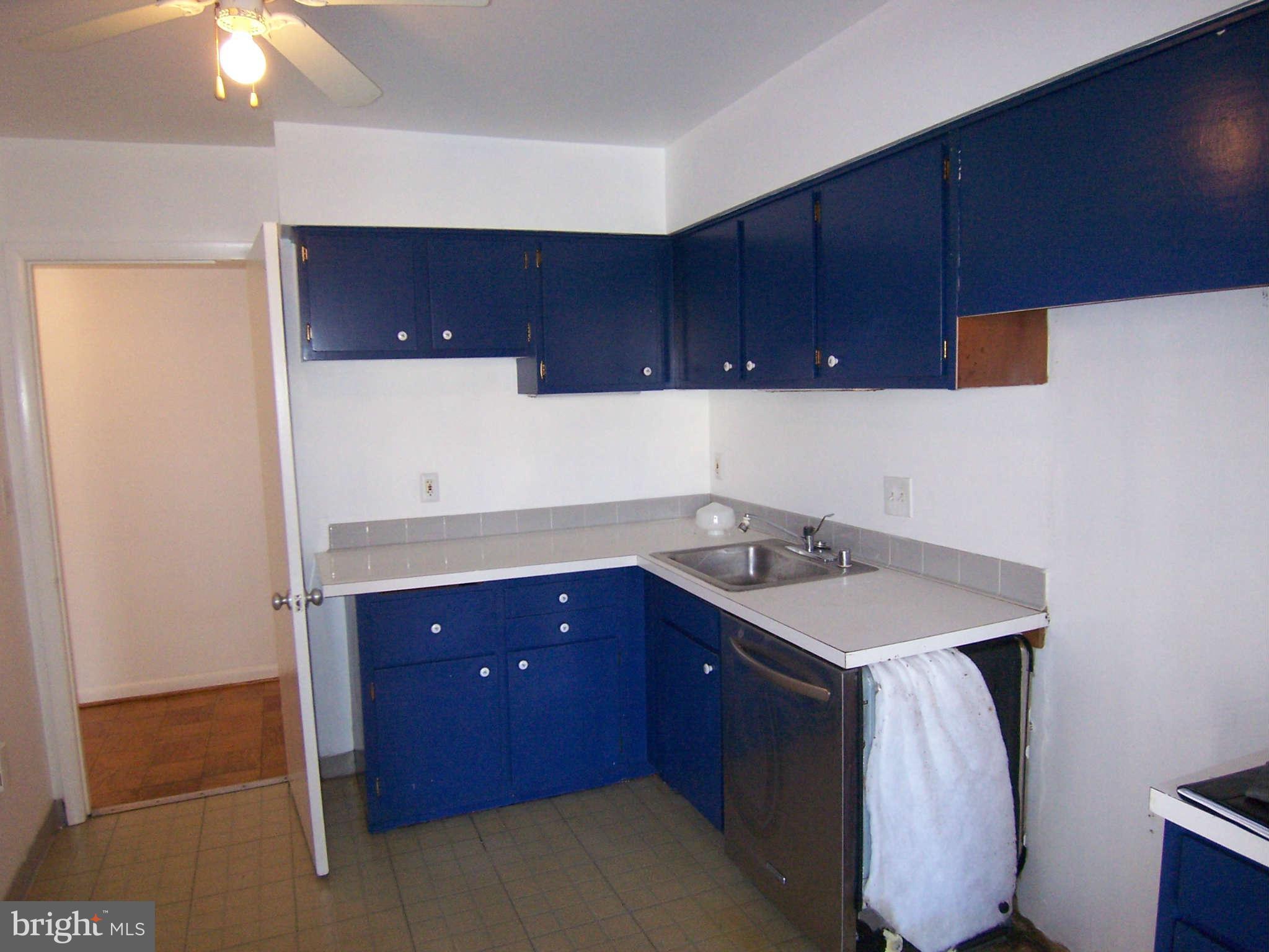 5 Cross Keys Road, Unit 5D Baltimore, MD 21210 - Photo 5 of 16 a room with a sink cabinets and utility