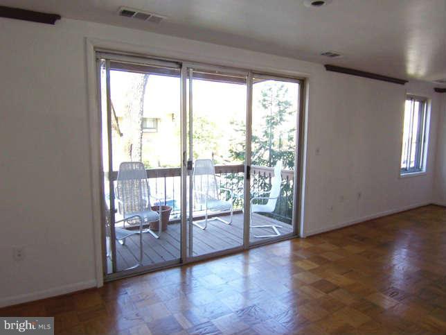 5 Cross Keys Road, Unit 5D Baltimore, MD 21210 - Photo 6 of 16 a view of a room with window and wooden floor