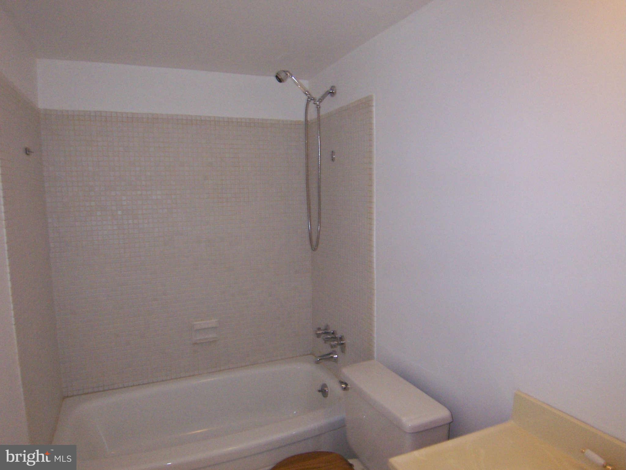 5 Cross Keys Road, Unit 5D Baltimore, MD 21210 - Photo 7 of 16 a bathroom with a bathtub and shower