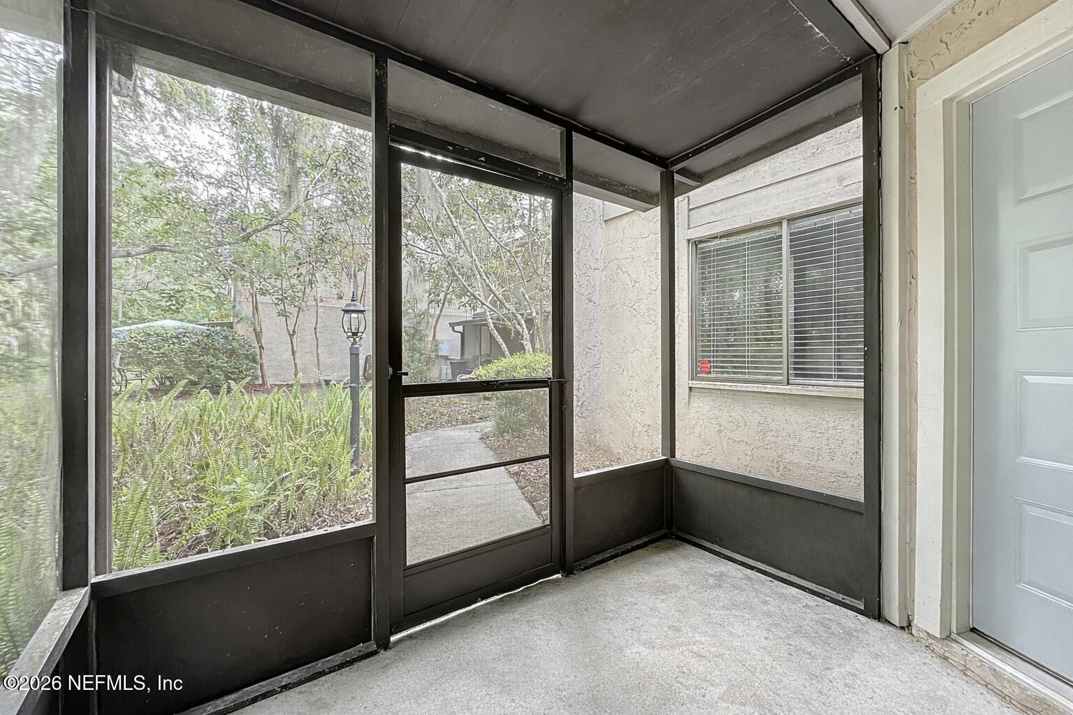 3801 Crown Point Road, Unit 1214 Jacksonville, FL 32257 - Photo 5 of 30 Screened-in porch with garden view
