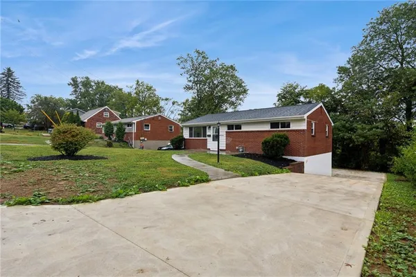 a front view of house with yard and green space