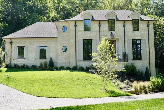 a front view of a house with a garden