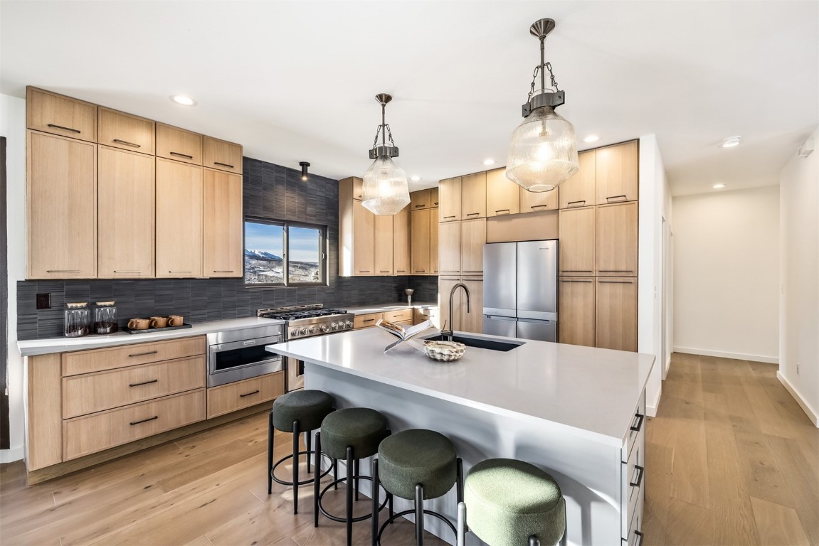 21 Stormwatch Circle Silverthorne, CO 80498 - Photo 11 of 43 a kitchen with a table chairs stove and cabinets