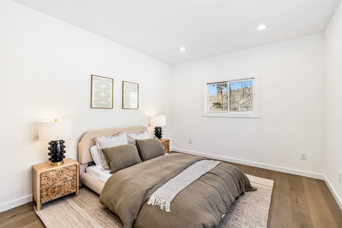 21 Stormwatch Circle Silverthorne, CO 80498 - Photo 22 of 43 a bed room with a bed and a painting on the wall
