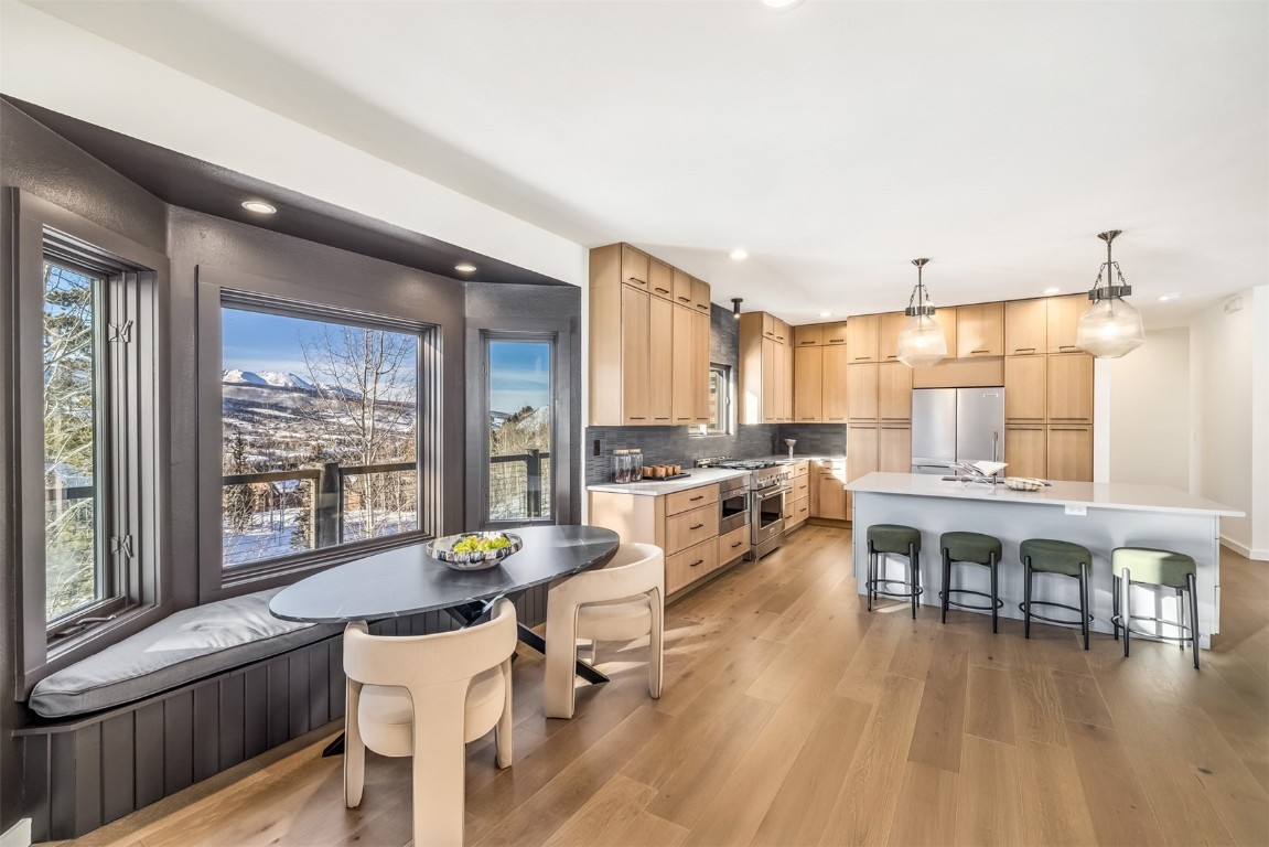 21 Stormwatch Circle Silverthorne, CO 80498 - Photo 8 of 43 a living room with furniture wooden floor and a large window