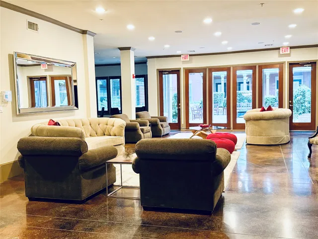 a living room with furniture and large windows