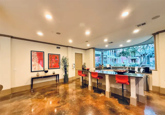 a living room with lots of furniture and kitchen view