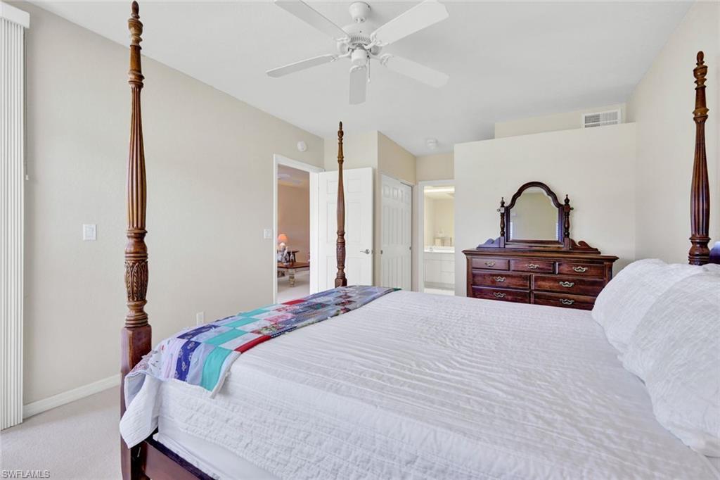 23731 Old Port Road, Unit 103 Estero, FL 34135 - Photo 11 of 30 a bedroom with a bed and a dresser