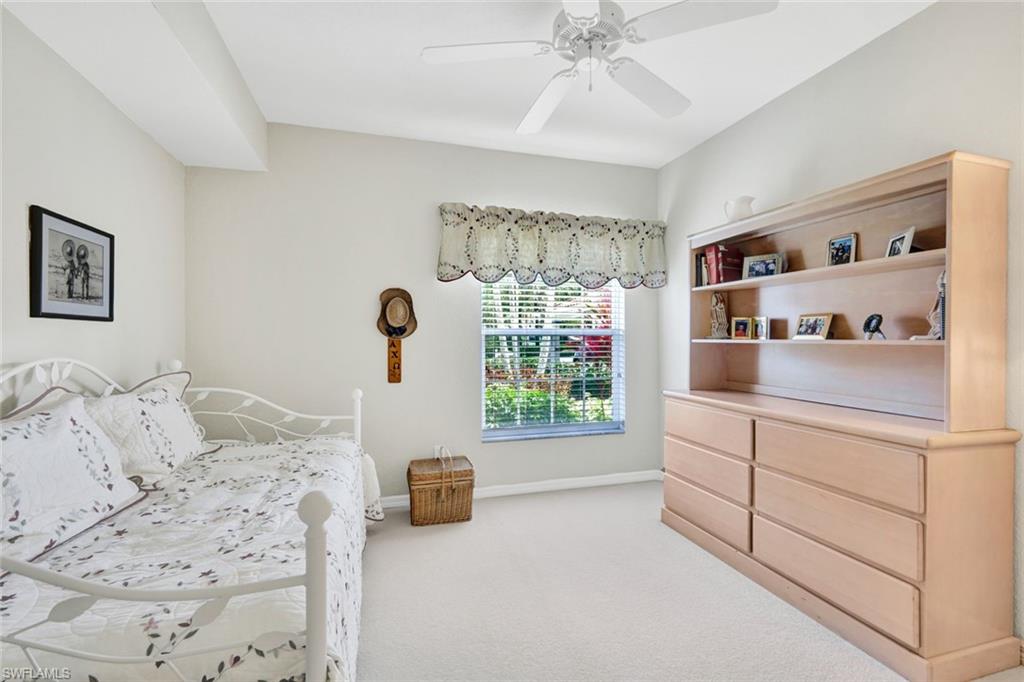 23731 Old Port Road, Unit 103 Estero, FL 34135 - Photo 13 of 30 a bedroom with a bed and a window