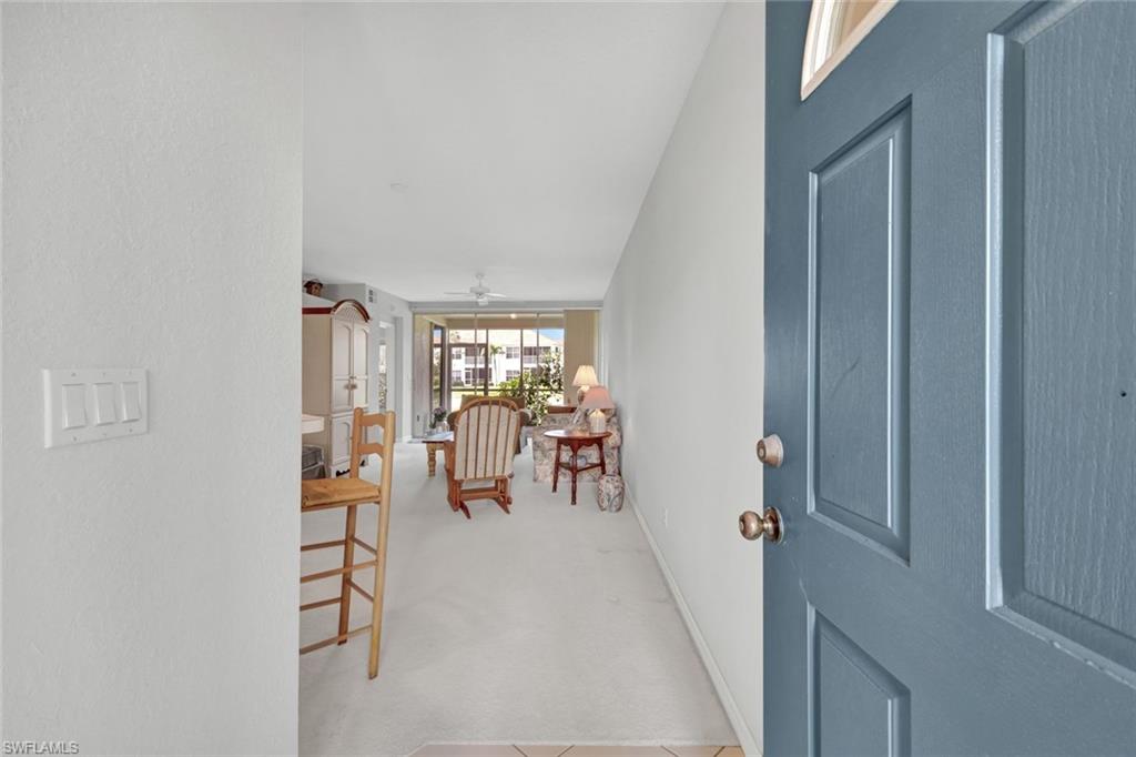 23731 Old Port Road, Unit 103 Estero, FL 34135 - Photo 2 of 30 a view of a livingroom with furniture and a window
