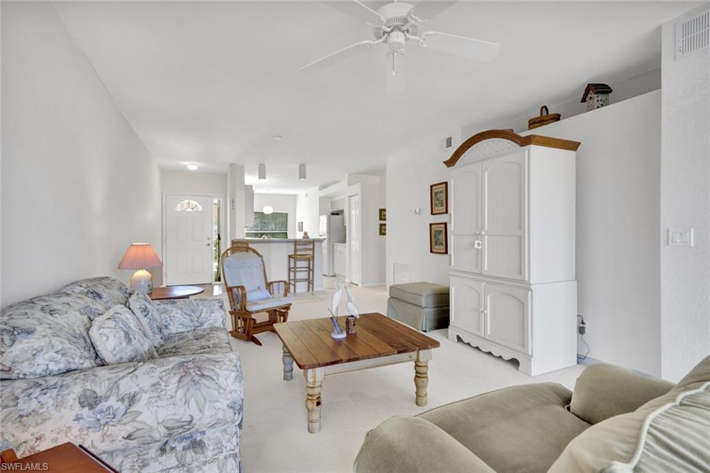 23731 Old Port Road, Unit 103 Estero, FL 34135 - Photo 4 of 30 a living room with furniture