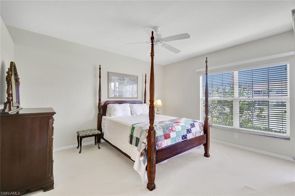 23731 Old Port Road, Unit 103 Estero, FL 34135 - Photo 10 of 30 a bedroom with bed and large window