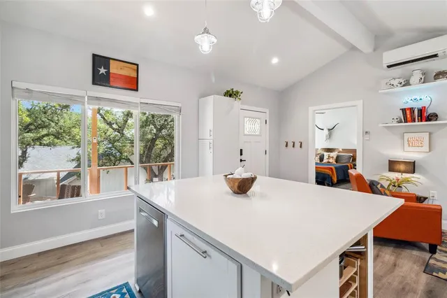 a kitchen with a sink appliances and cabinets
