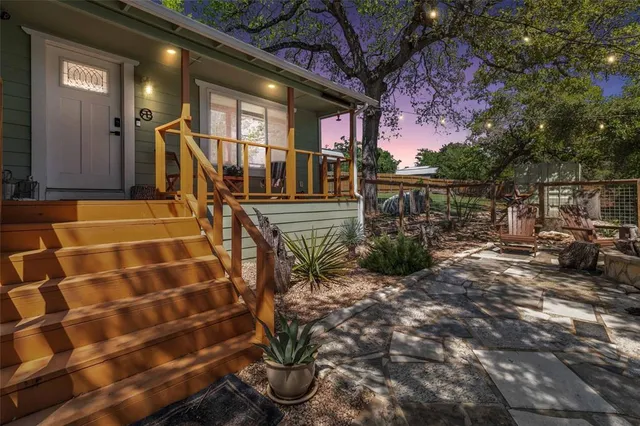 a view of a porch with furniture and a yard