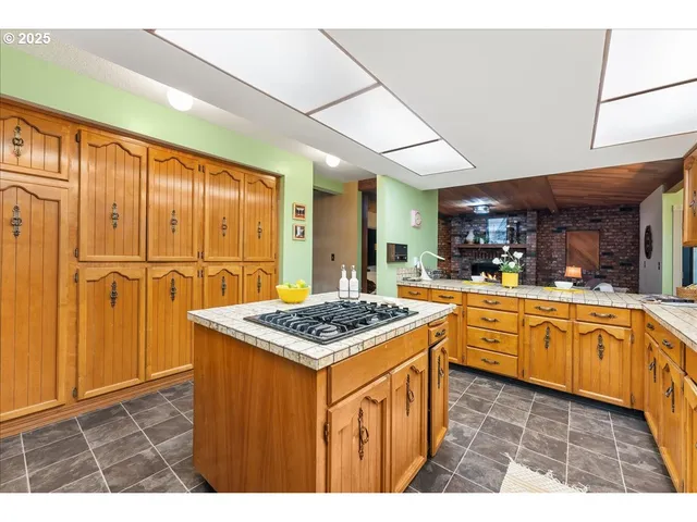 a kitchen with stainless steel appliances granite countertop a stove a sink dishwasher and cabinets with wooden floor