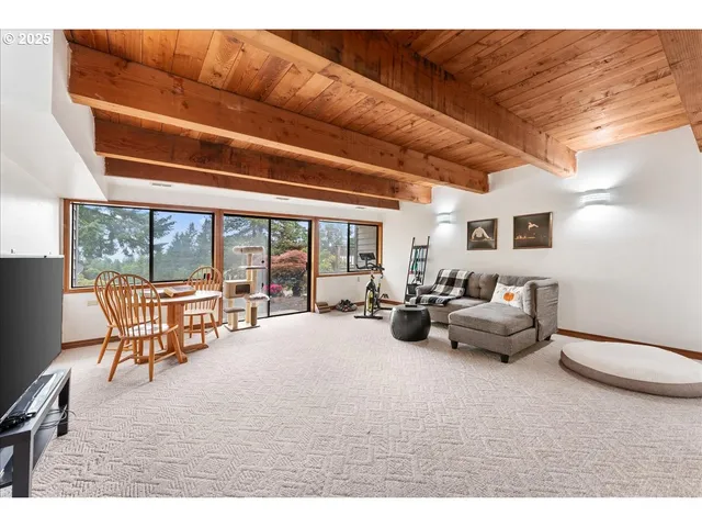 a living room with furniture and a floor to ceiling window