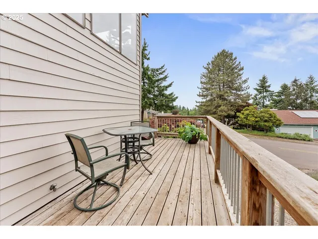 a view of balcony with wooden floor and outdoor seating