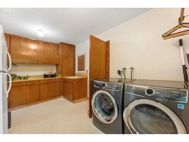 a view of washer and dryer with kitchen in the background