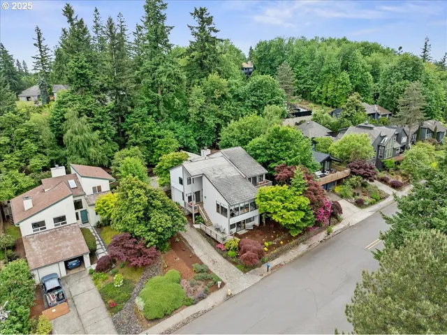 an aerial view of a house with garden space and street view