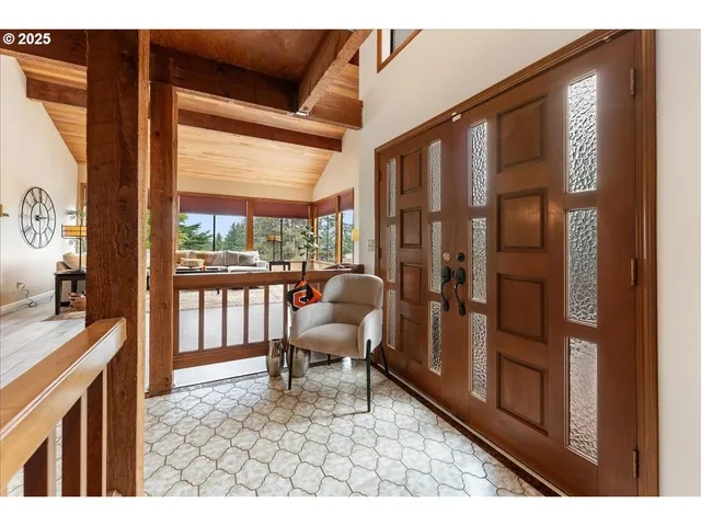 a living room with furniture tv and a floor to ceiling window