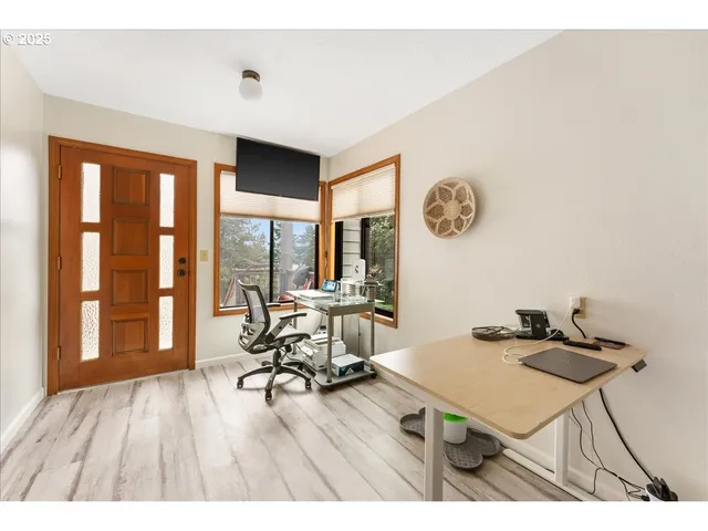 a view of a workspace with furniture and a window
