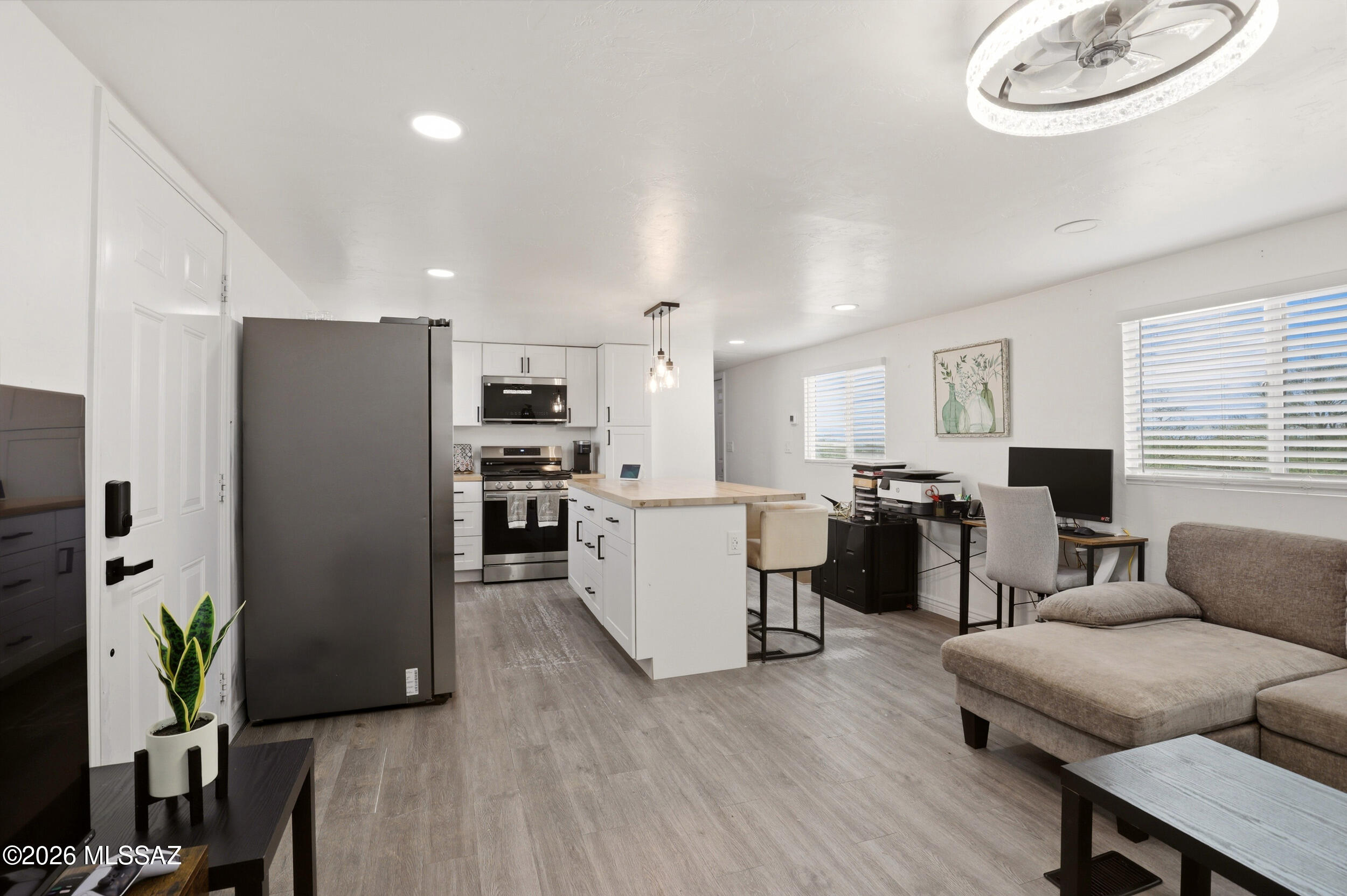 8620 South Sandario Road Tucson, AZ 85736 - Photo 6 of 26 a living room with furniture kitchen view and a refrigerator
