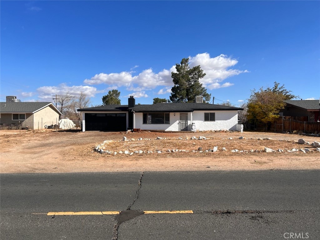 14059 Pawnee Road Apple Valley, CA 92307 - Photo 1 of 1 a view of a house with a snow on the road