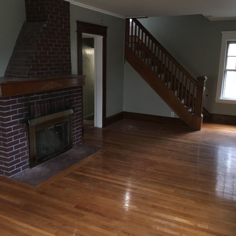 101 Belvidere Street Springfield, MA 01108 - Photo 6 of 15 a view of a livingroom with wooden floor and a fireplace