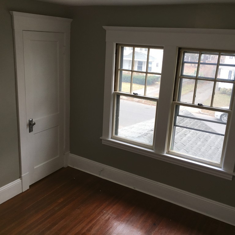101 Belvidere Street Springfield, MA 01108 - Photo 8 of 15 a view of an empty room with wooden floor and a window