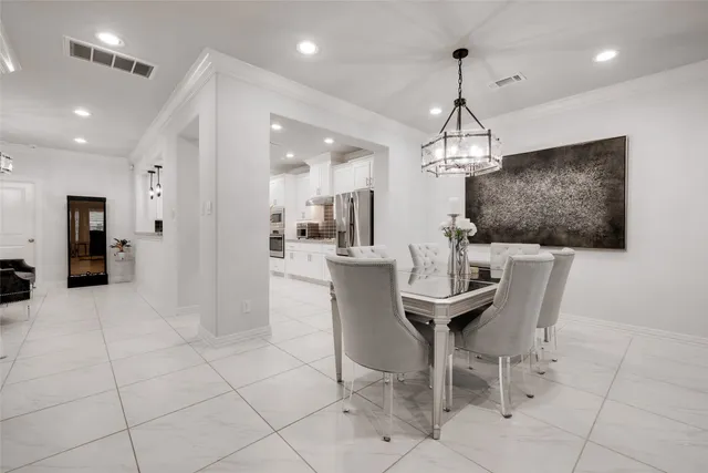 a dining room with furniture and a chandelier