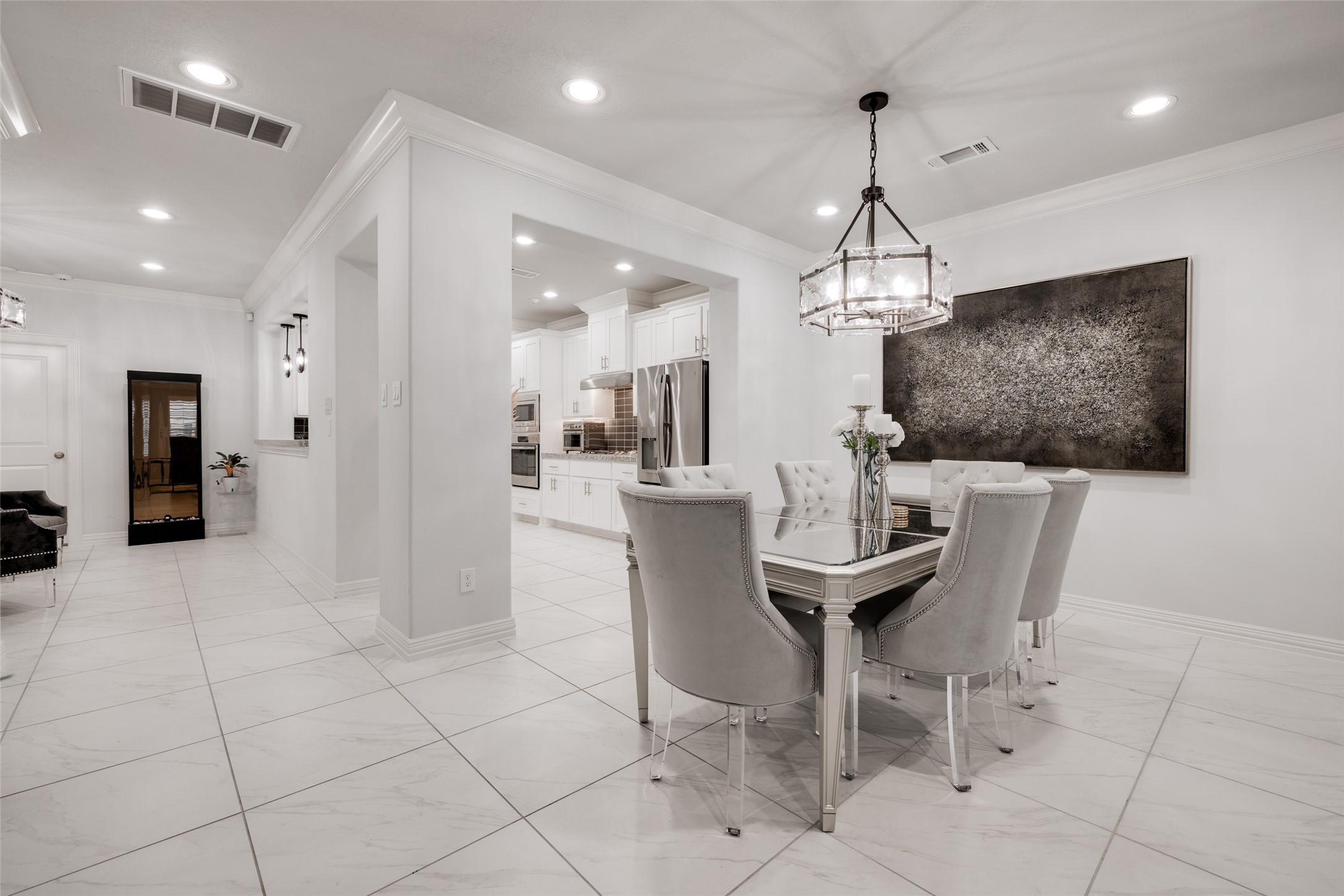 13611 Teal Bluff Lane Houston, TX 77077 - Photo 12 of 46 a dining room with furniture and a chandelier