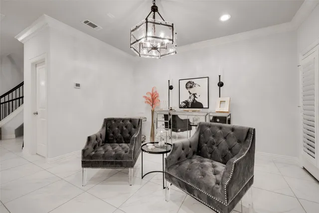 a living room with furniture and a chandelier