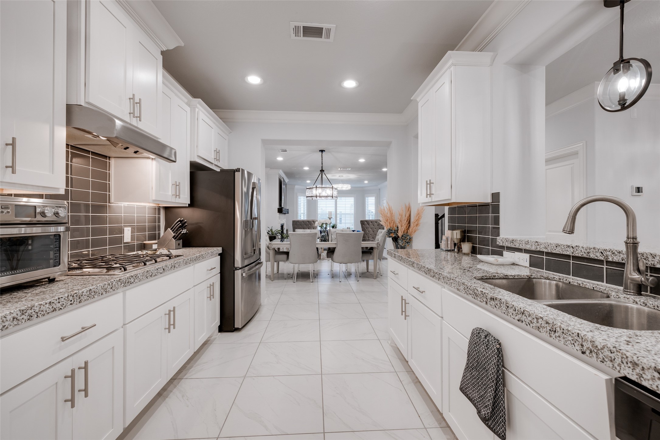 13611 Teal Bluff Lane Houston, TX 77077 - Photo 23 of 46 a kitchen with stainless steel appliances granite countertop a sink refrigerator and cabinets