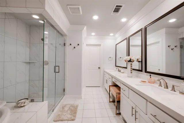 a white bath tub sitting next to a shower