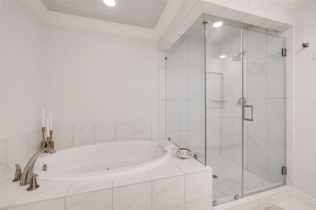 a bathroom with a tub a sink and mirror