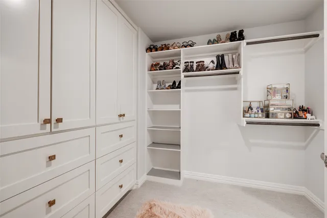 a view of walk in closet with empty racks