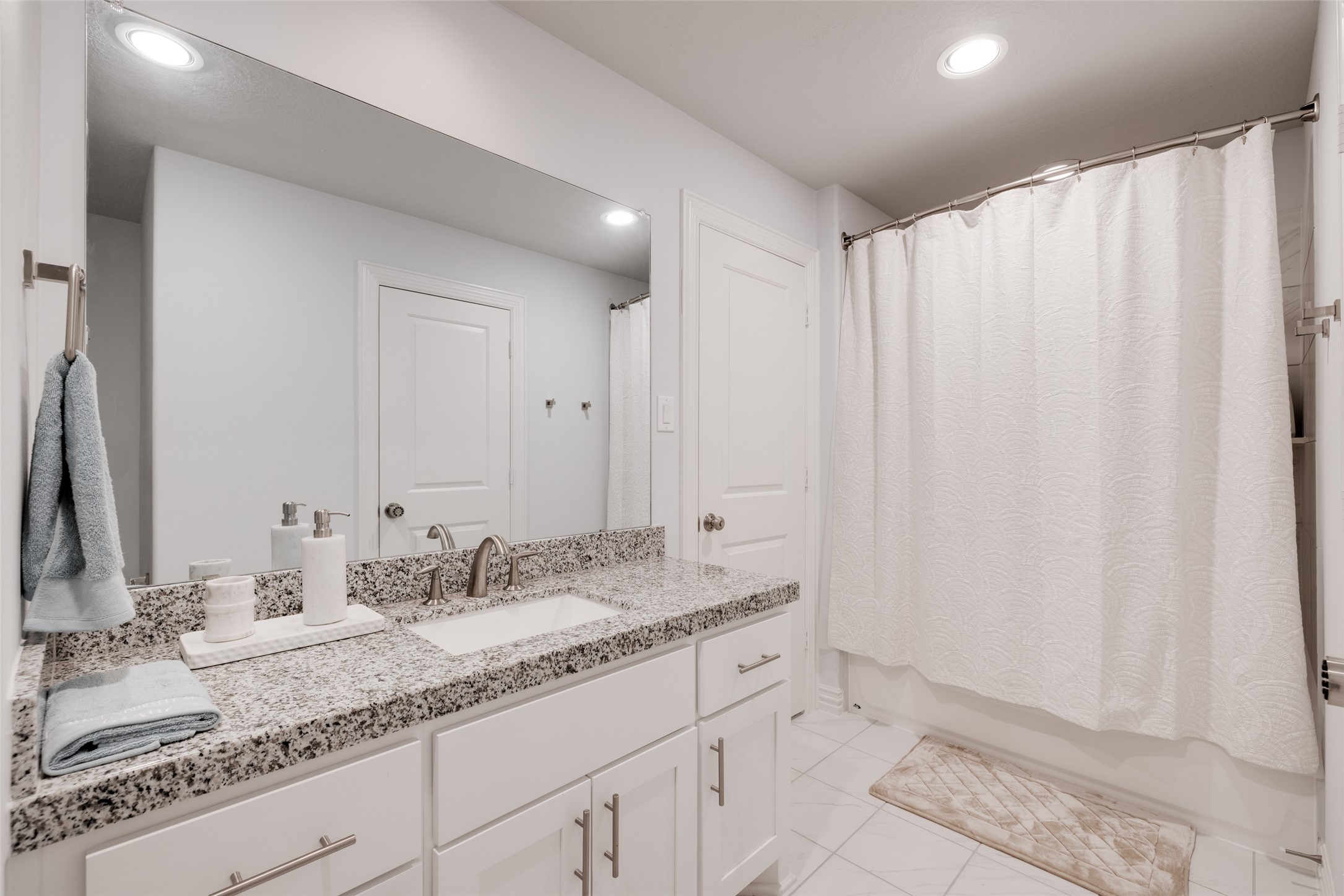 13611 Teal Bluff Lane Houston, TX 77077 - Photo 39 of 46 a bathroom with a granite countertop sink and a mirror