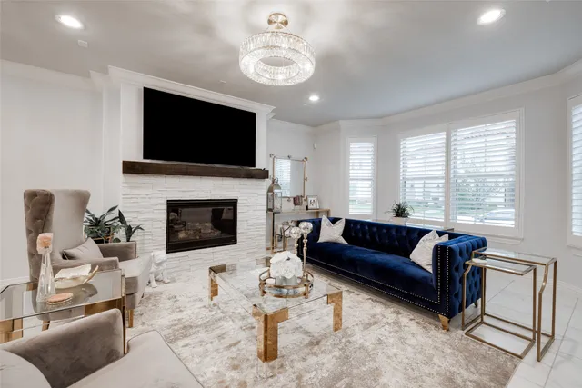 a living room with furniture a flat screen tv and a fireplace