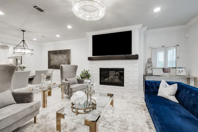 a living room with furniture a flat screen tv and a fireplace