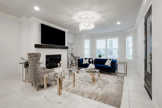 a living room with furniture a flat screen tv and a fireplace